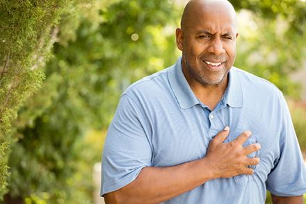 bald man holding chest