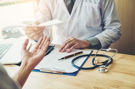 close-up-of-doctor-hands-sharing-tests with patient