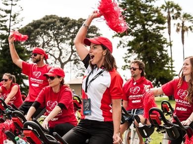 excited people on stationary bikes