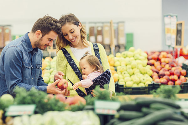 couple and baby grocery shopping