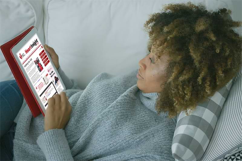 Woman reading Heart Insight on tablet