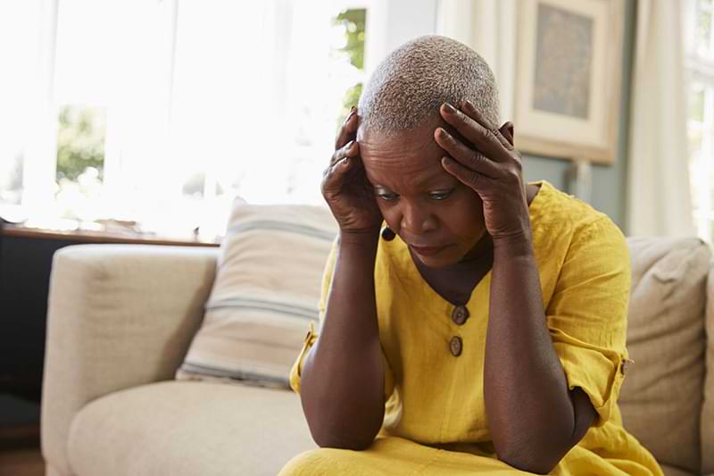 senior woman holding head