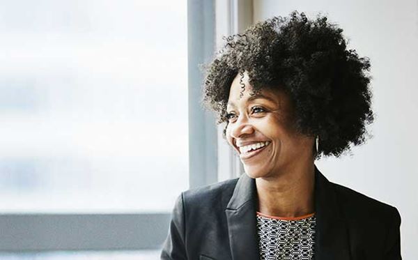 smiling business woman looking outside office window