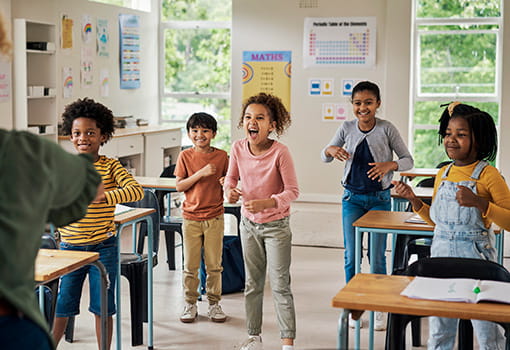 Teacher teaching young students an fitness program in the classroom