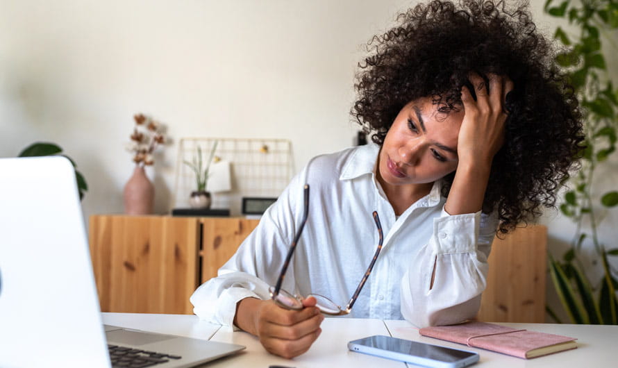 Women feeling stress sitting in front of her laptop.